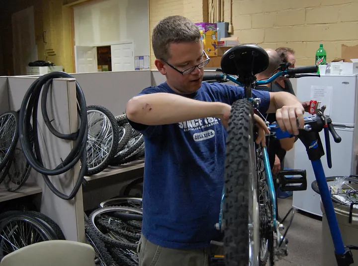 Photo Of A Man Fixing A Bike